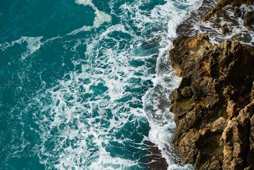 Free Aerial Photography of Body of Water Beside Rock Formation Stock Photo