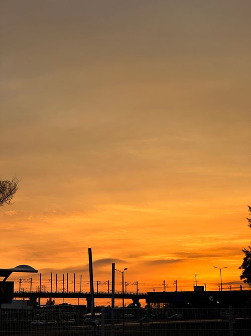 Free Silhouette of train tracks against a vivid orange sunset sky, highlighting urban travel and tranquility. Stock Photo