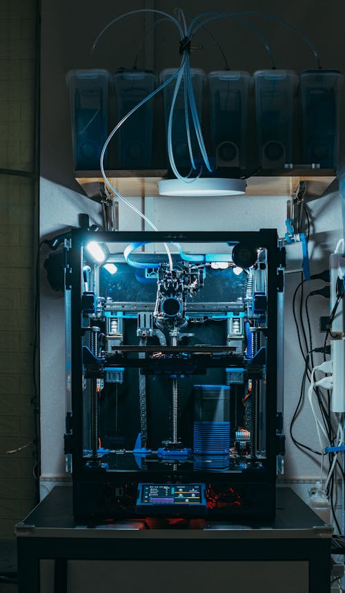 A 3d printer with a blue light on it
