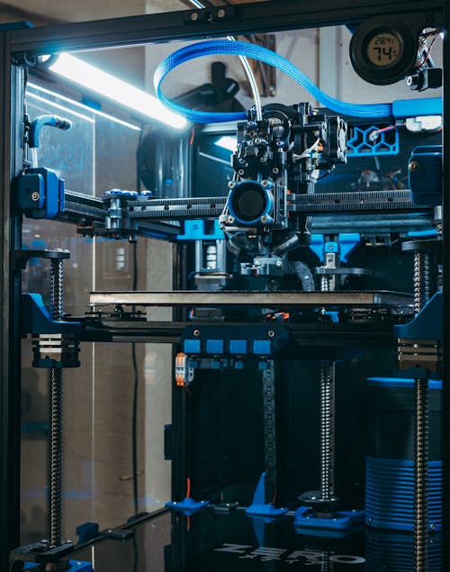 A 3d printer with blue lights and a blue light