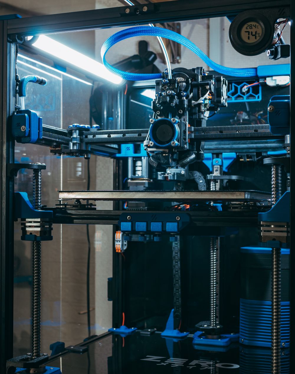 A 3D printer running in an industrial workshop — photo by FOX on Pexels