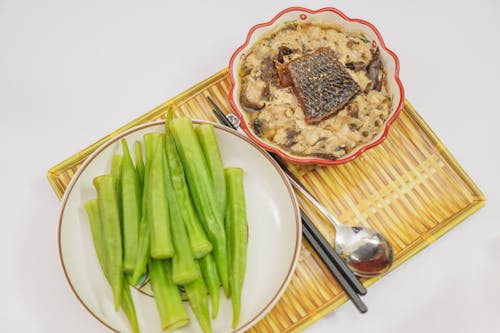 A plate with rice, celery and a spoon