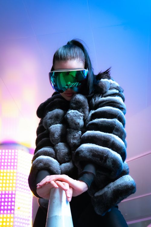 Free Stylish portrait of a woman in fur and visor glasses, showcasing modern fashion trends. Stock Photo