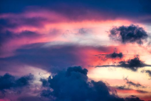 A vibrant and dramatic sunset sky with colorful clouds displaying a beautiful natural gradient.