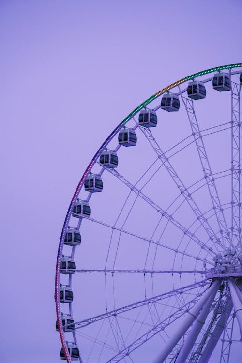 A ferris wheel is shown in the sky