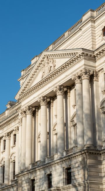 Elegant facade of a classical building with ornate columns in London.