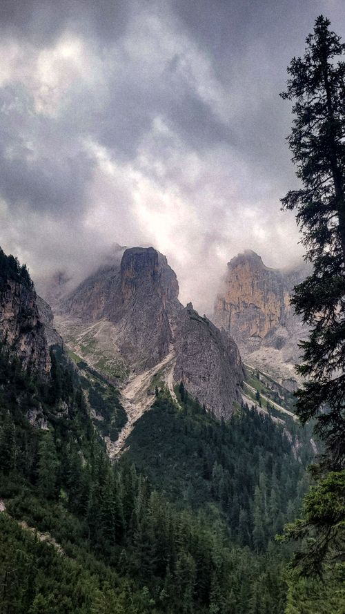 Free Dramatic landscape of Dolomite mountains in Trentino, Italy. Captivating rocky terrain under cloudy skies. Stock Photo