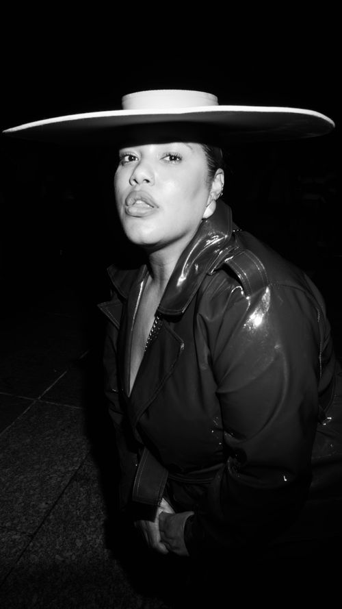 Free Striking monochrome portrait of a woman wearing a wide-brimmed hat and leather jacket. Stock Photo