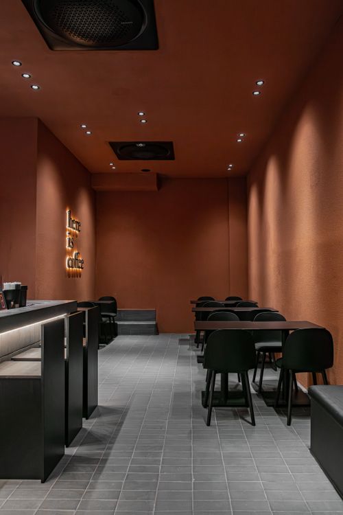 Free An empty modern coffee shop with minimalistic design and warm lighting, showcasing contemporary furniture. Stock Photo