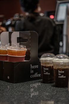 Close-up of takeaway coffee cups on a cafe counter