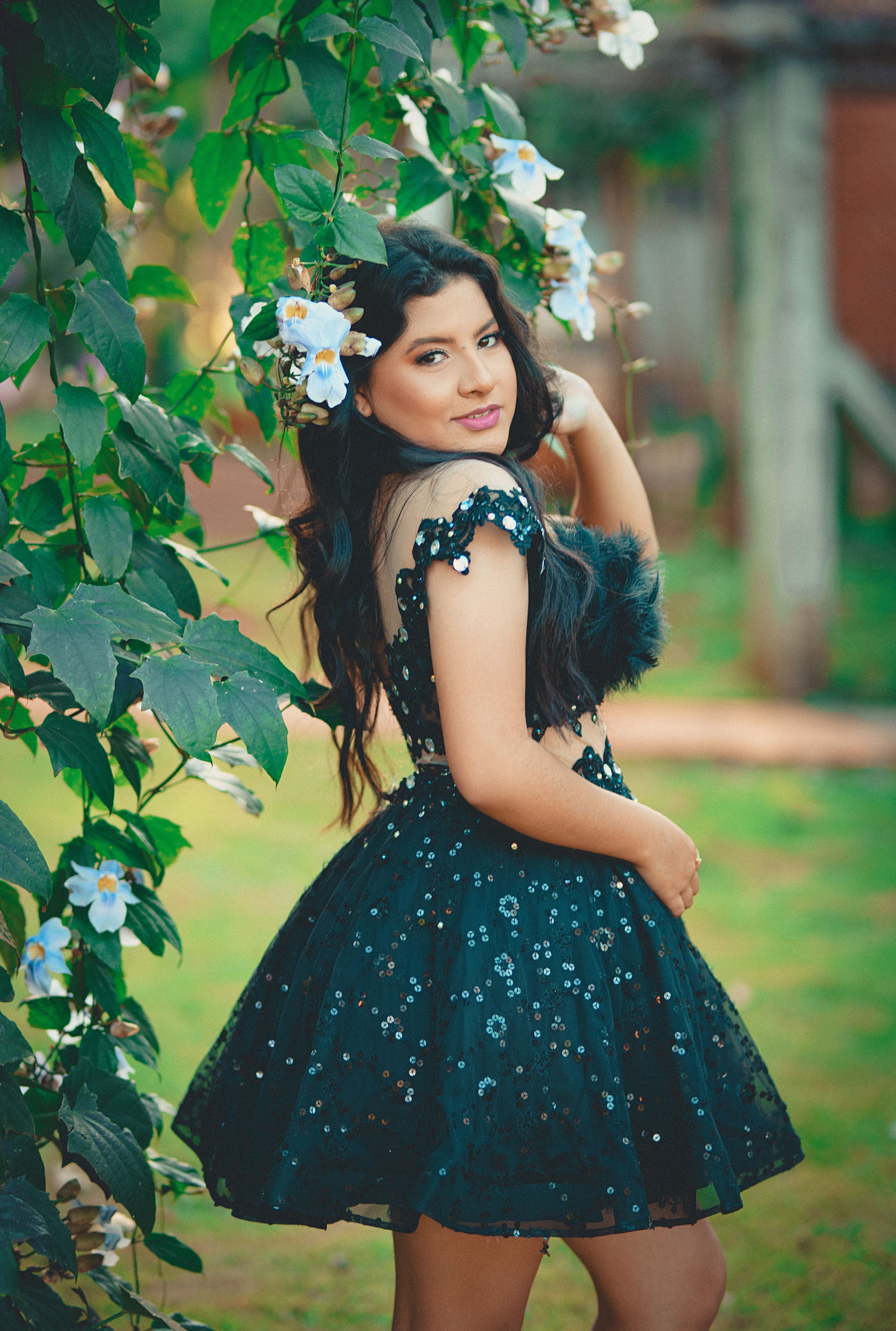 A beautiful young woman in a black dress posing for the camera · Free ...