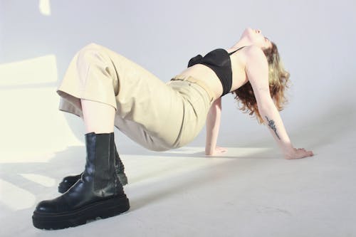 Blonde Woman in Bra and Pants Posing in Studio