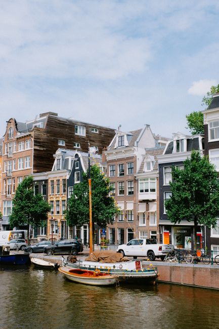 Beautiful canal view in Amsterdam with historic buildings and boats, perfect for travel imagery.
