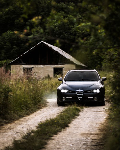 Black Alfa Romeo 159 on Dirt Road