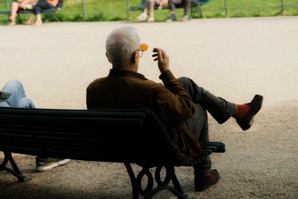 Older man relaxing on a park bench