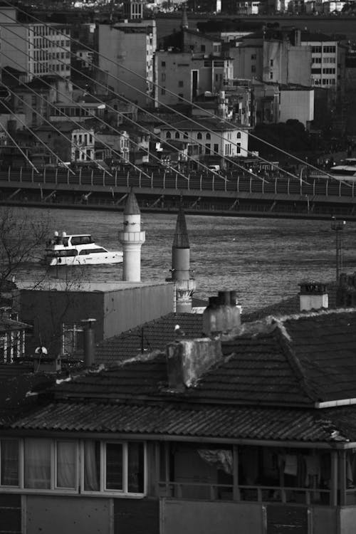 Roofs of Buildings near Coast of Istanbul with Halic Bridge in Black and White