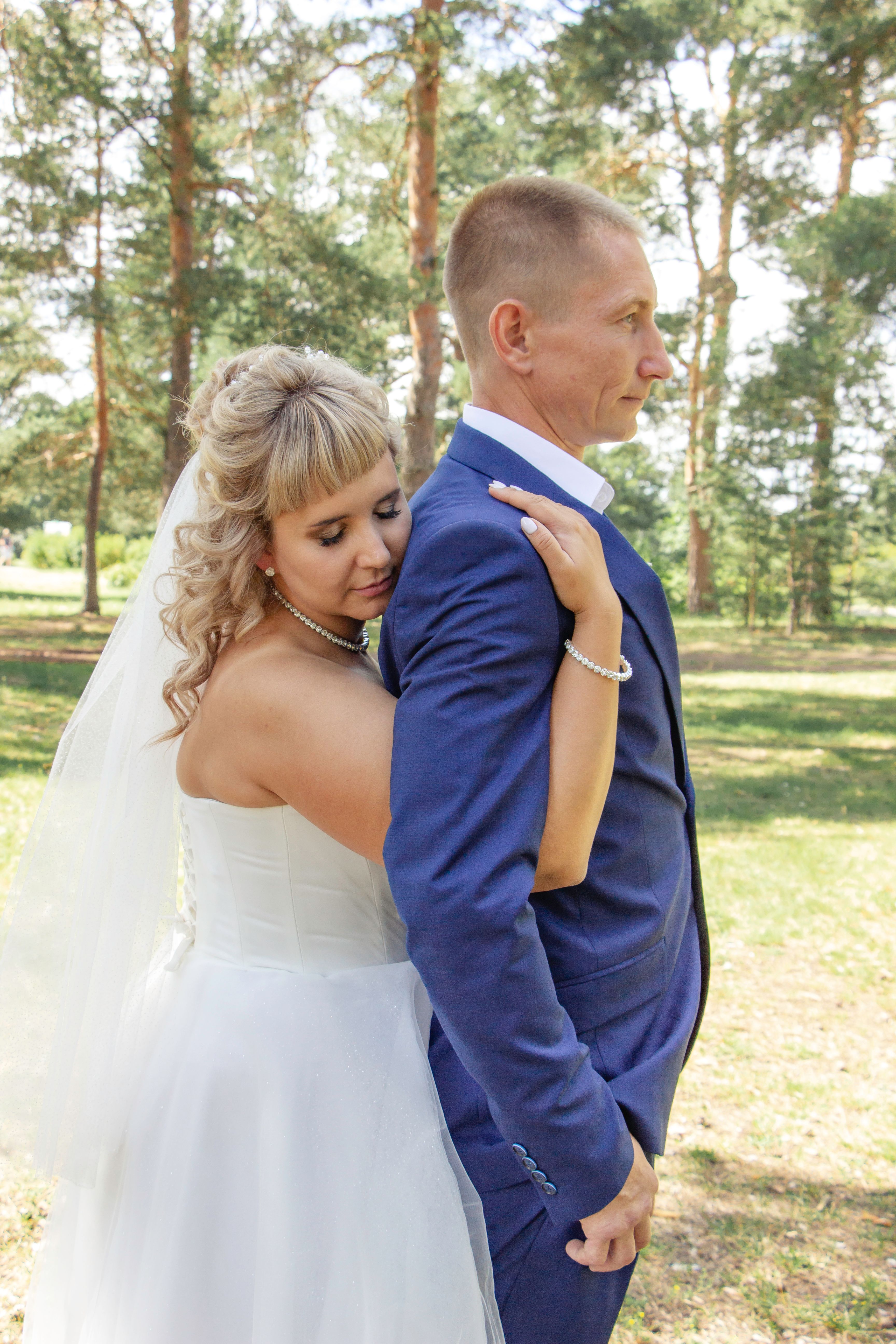 A bride and groom hugging in the woods · Free Stock Photo