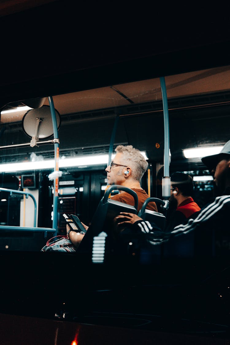 Man With Earphones Riding On Bus