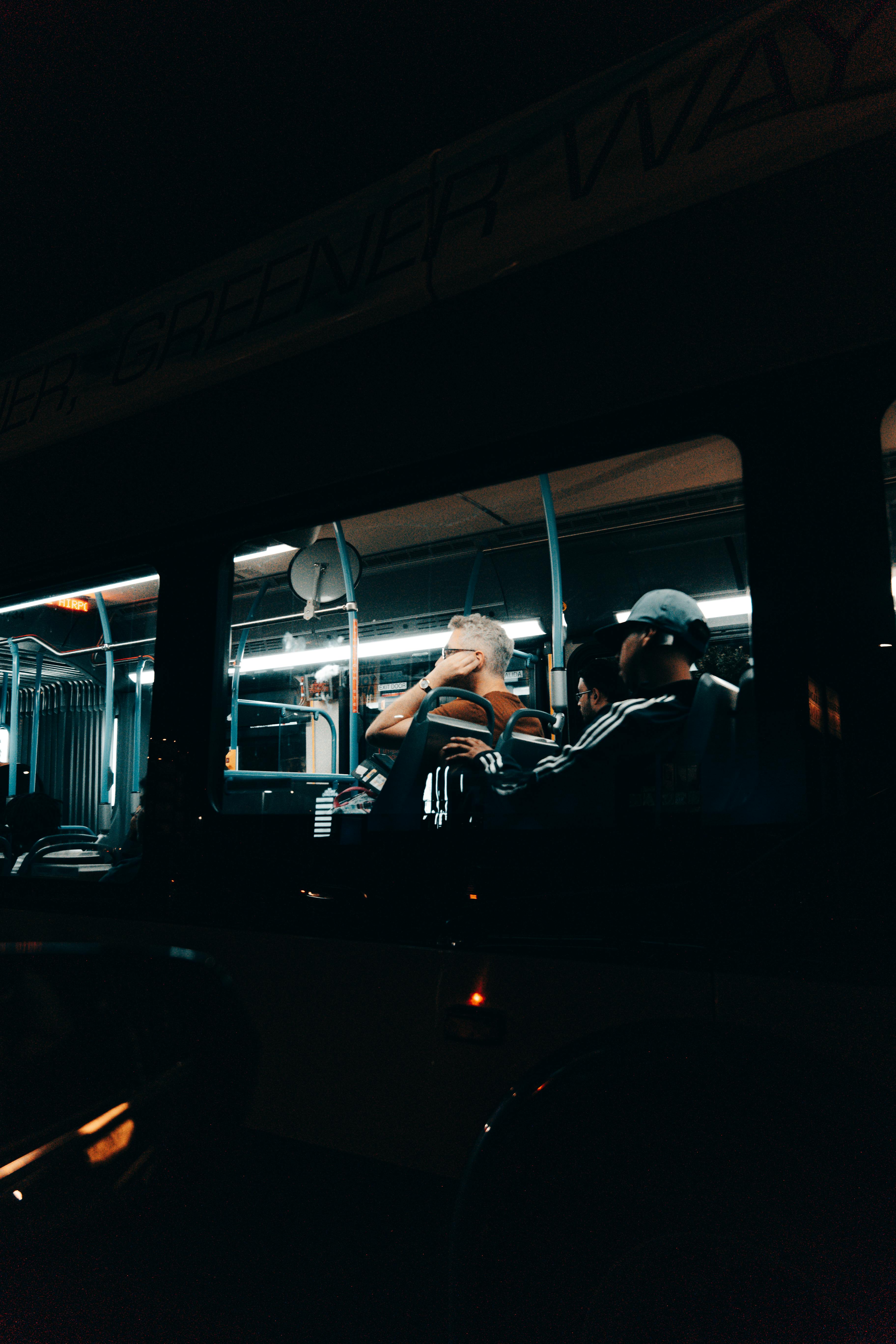 a man sitting in a bus at night