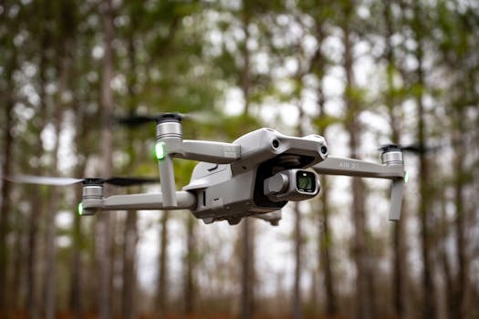 Close-up of a drone in midair with trees in the background, showcasing technology and nature.