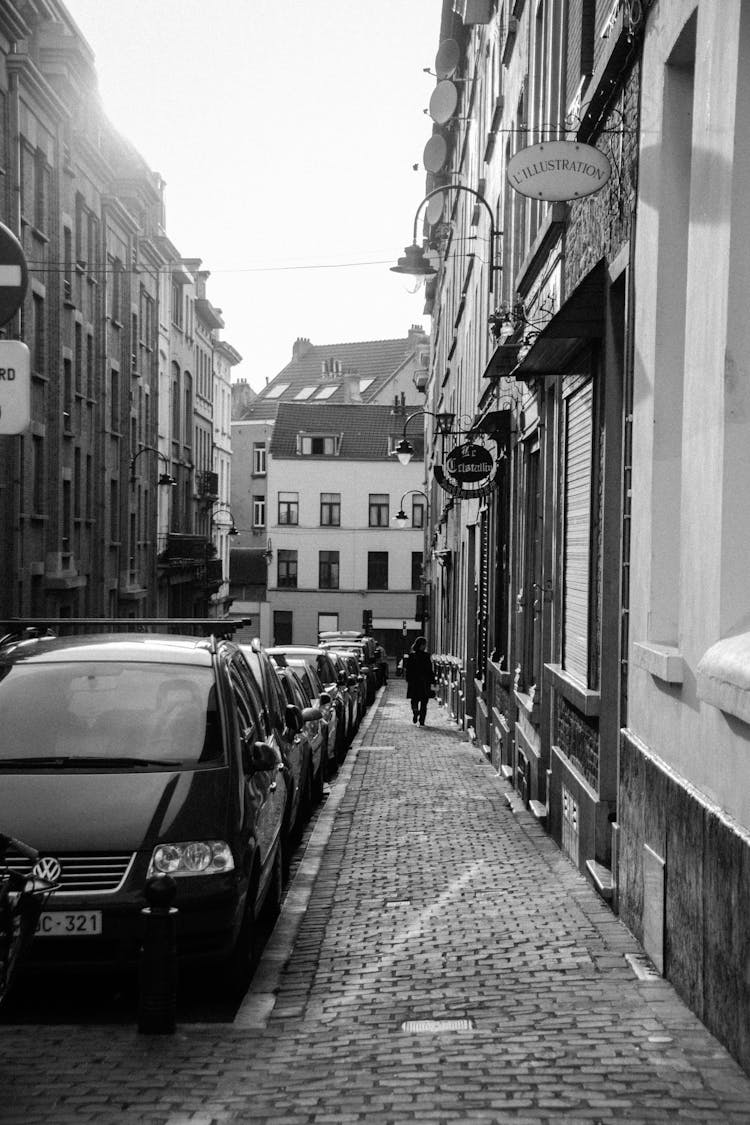 Grayscale Photography Of Cars Parked On Side Of Road