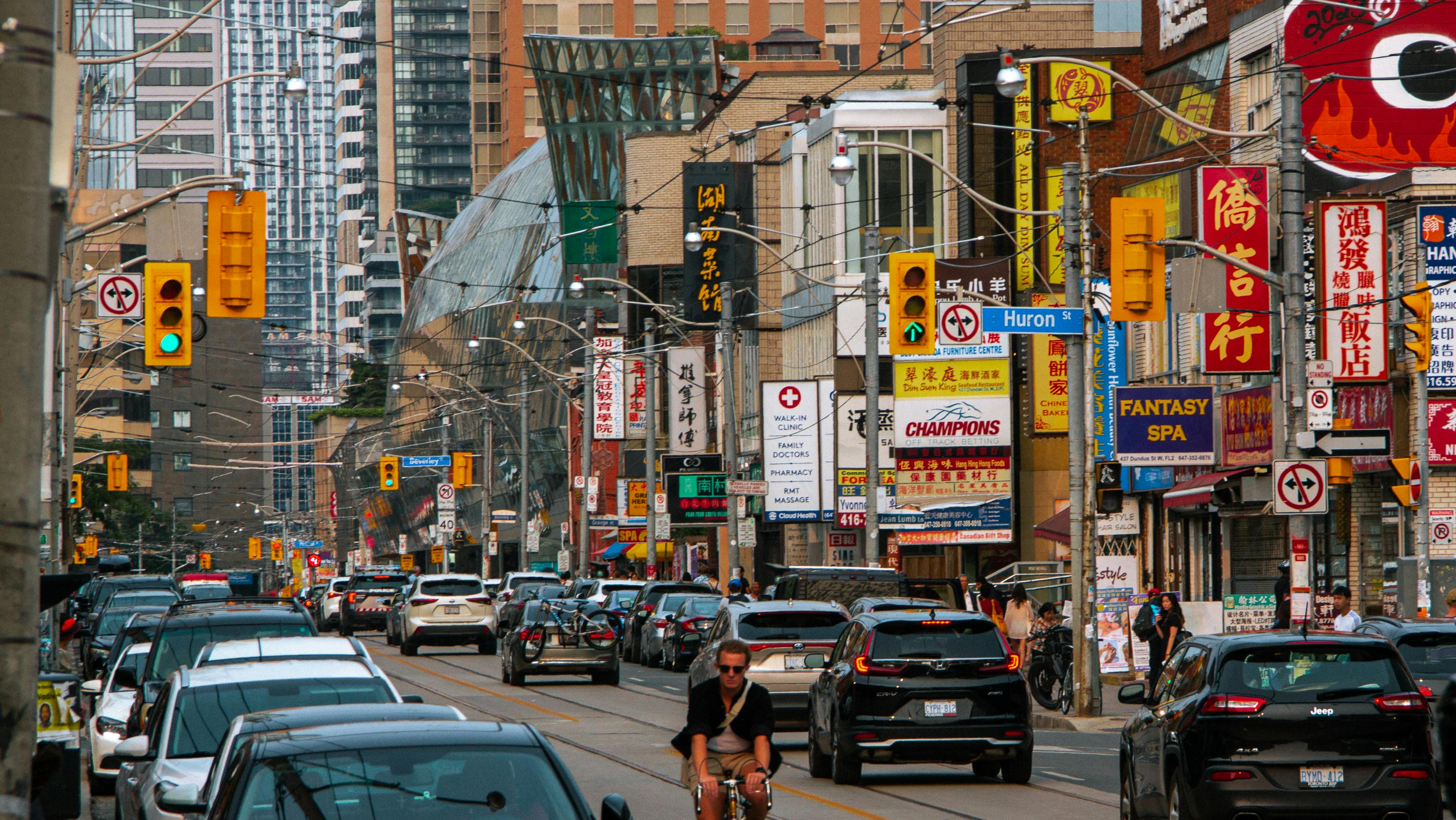 a busy city street with many cars and people