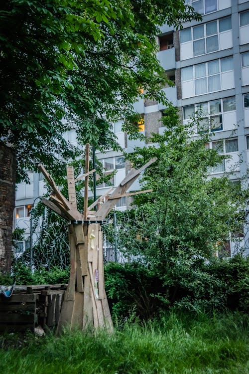 Wooden Sculpture Near Tree during Day