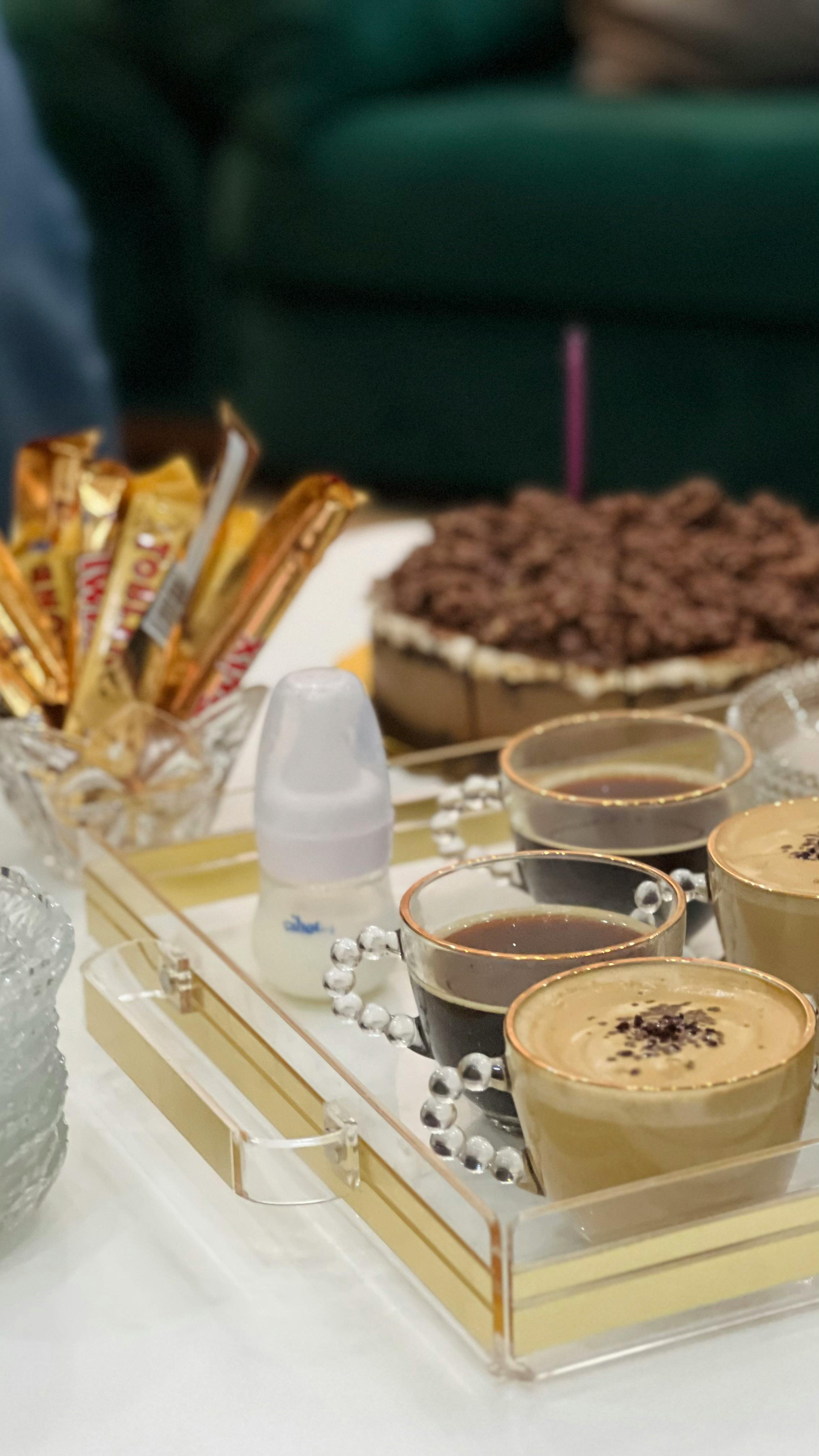 a tray with coffee cups and chocolate on it