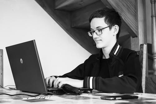 Man Working on Laptop in Black and White 