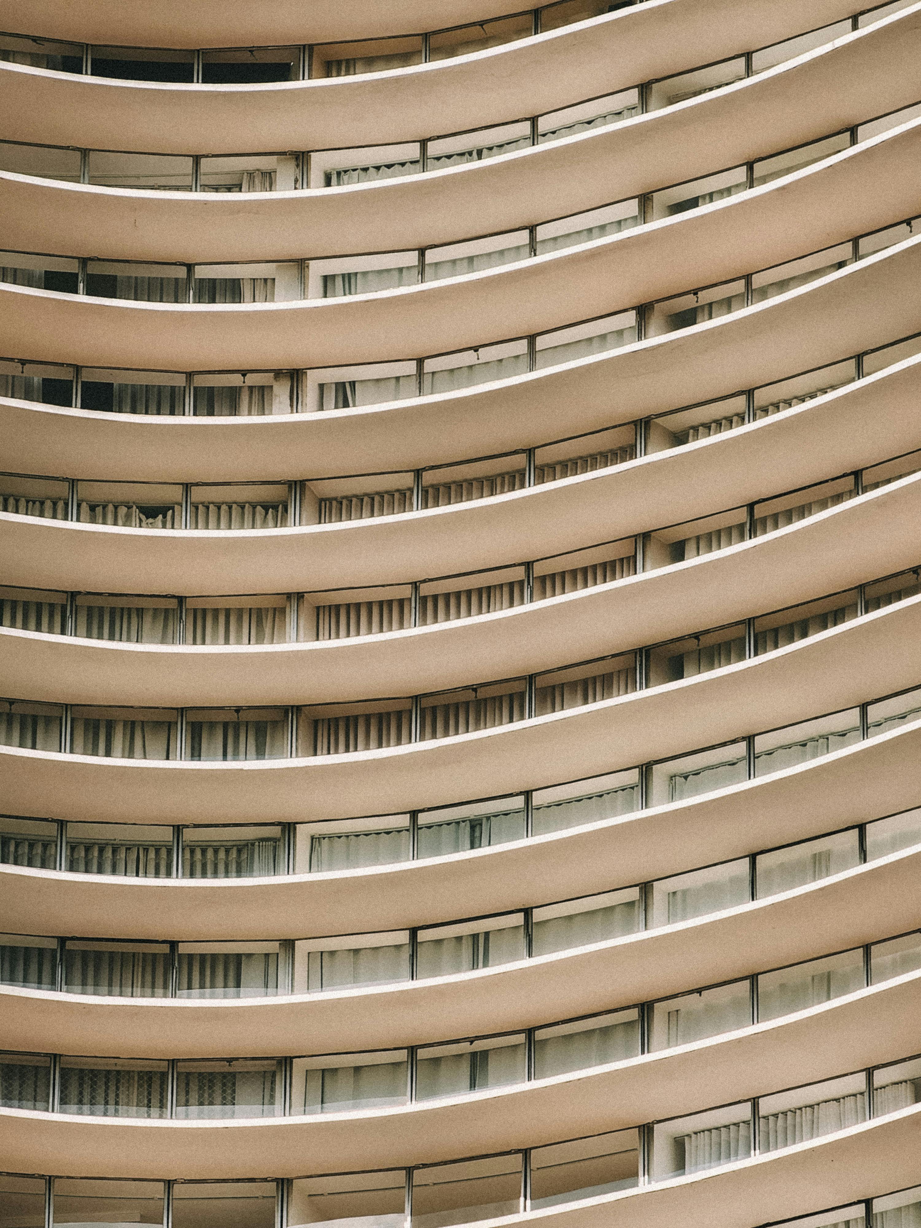 Close-up of a modern urban building with distinct curved balconies and architectural design.