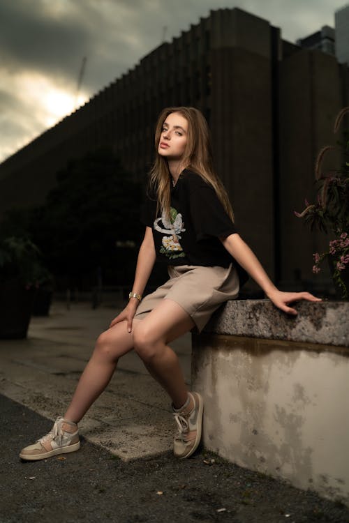 Blonde Woman Sitting on Wall