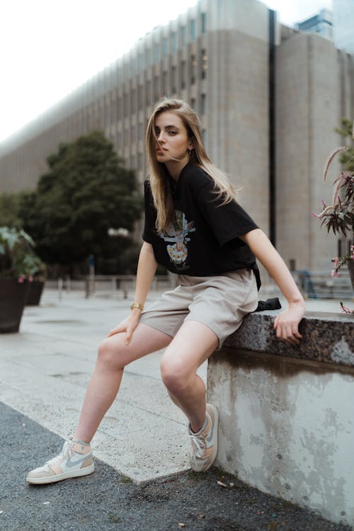 Blonde Woman Sitting on Wall