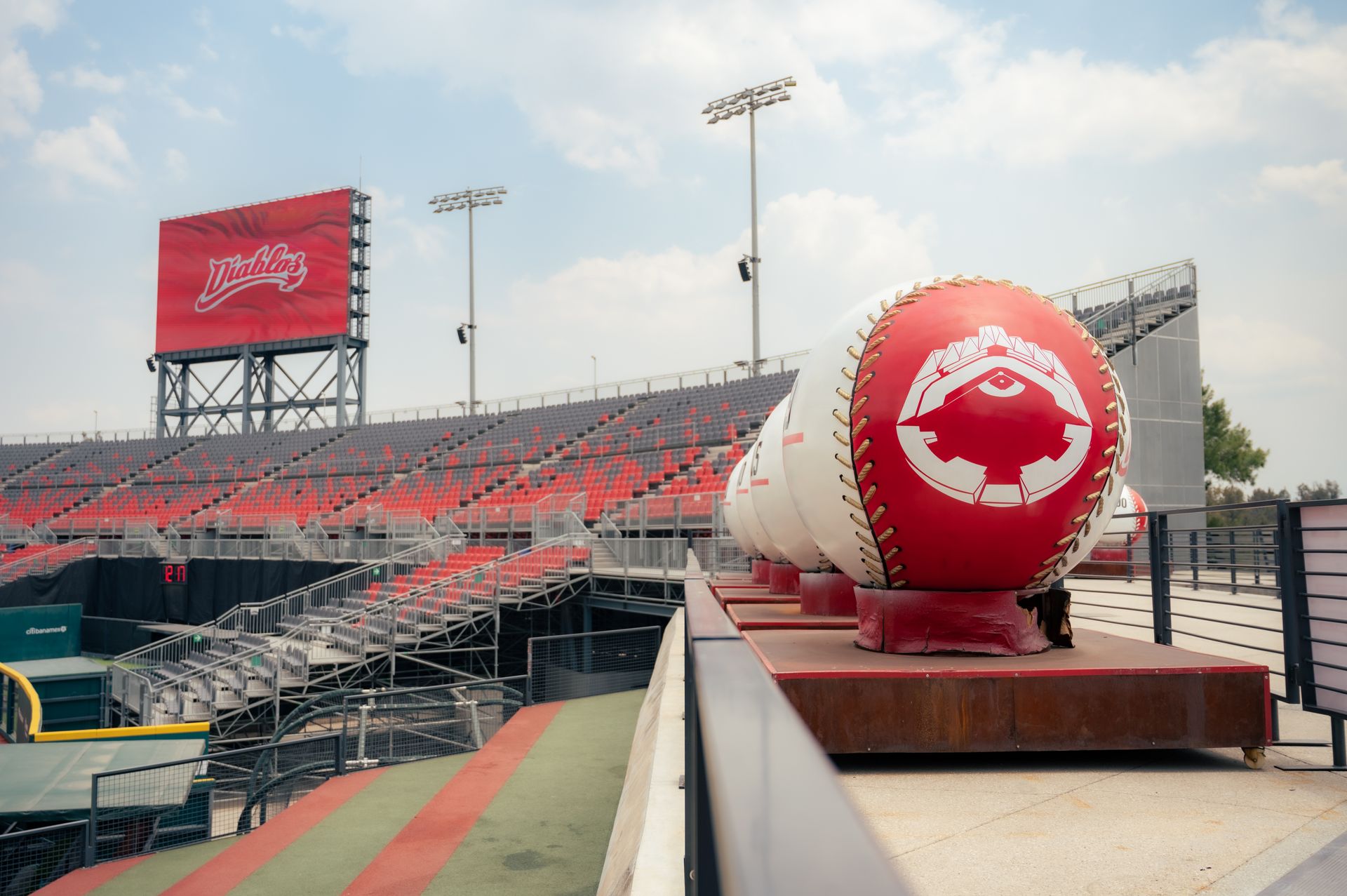 A baseball stadium with a red and white scoreboard