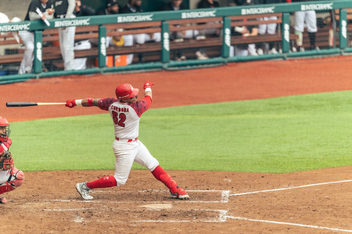 Baseball player swinging through full torso rotation — the rotational power moment