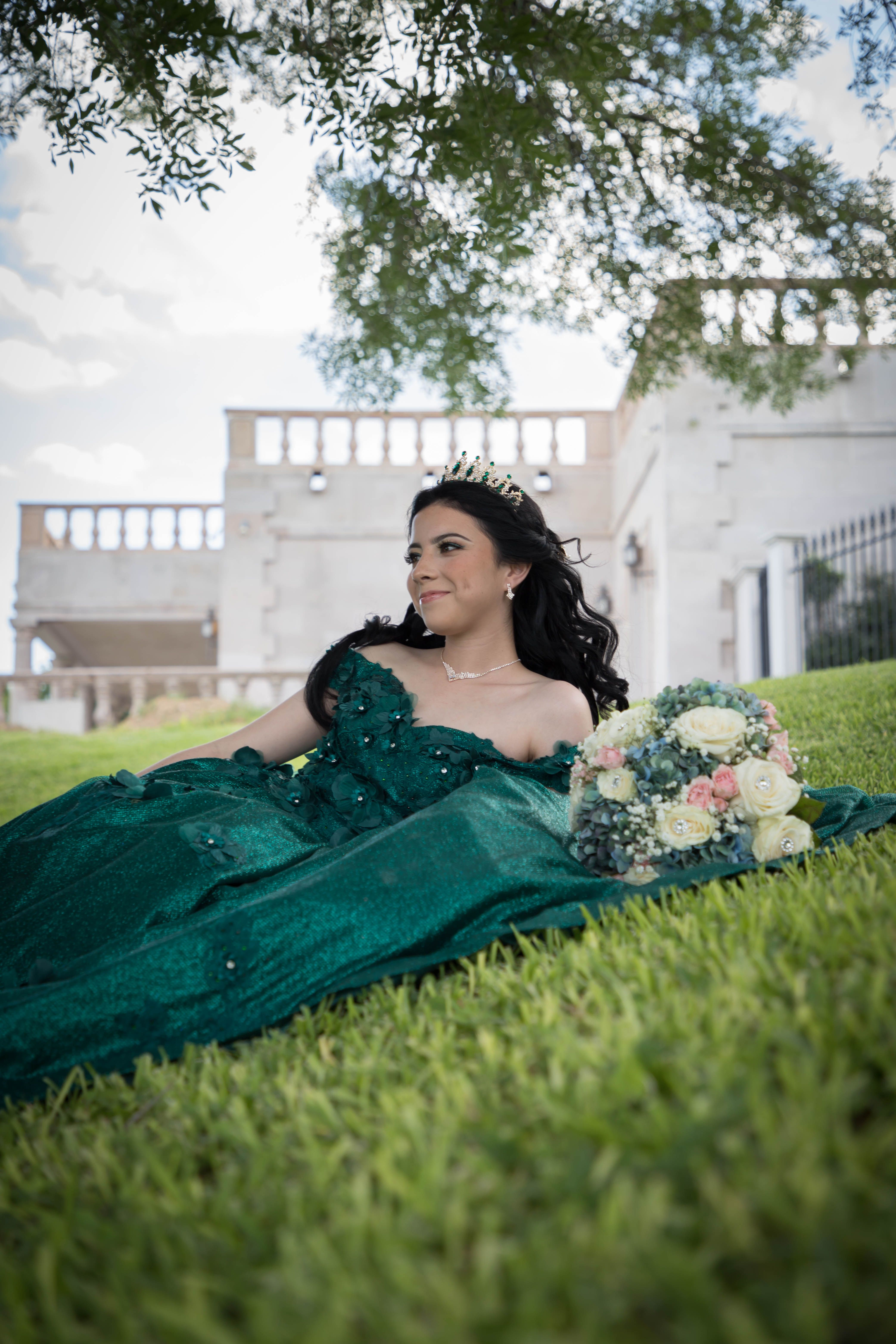 A woman in a green dress laying on the grass · Free Stock Photo