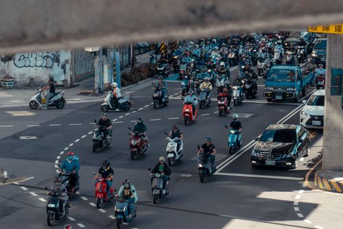 Free Crowded city street in Taipei with motorbikes and vehicles navigating through a busy intersection. Stock Photo