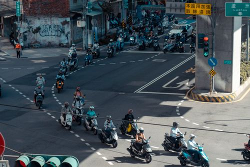 Free Motorcycles traverse a bustling intersection in Taipei, Taiwan. Stock Photo