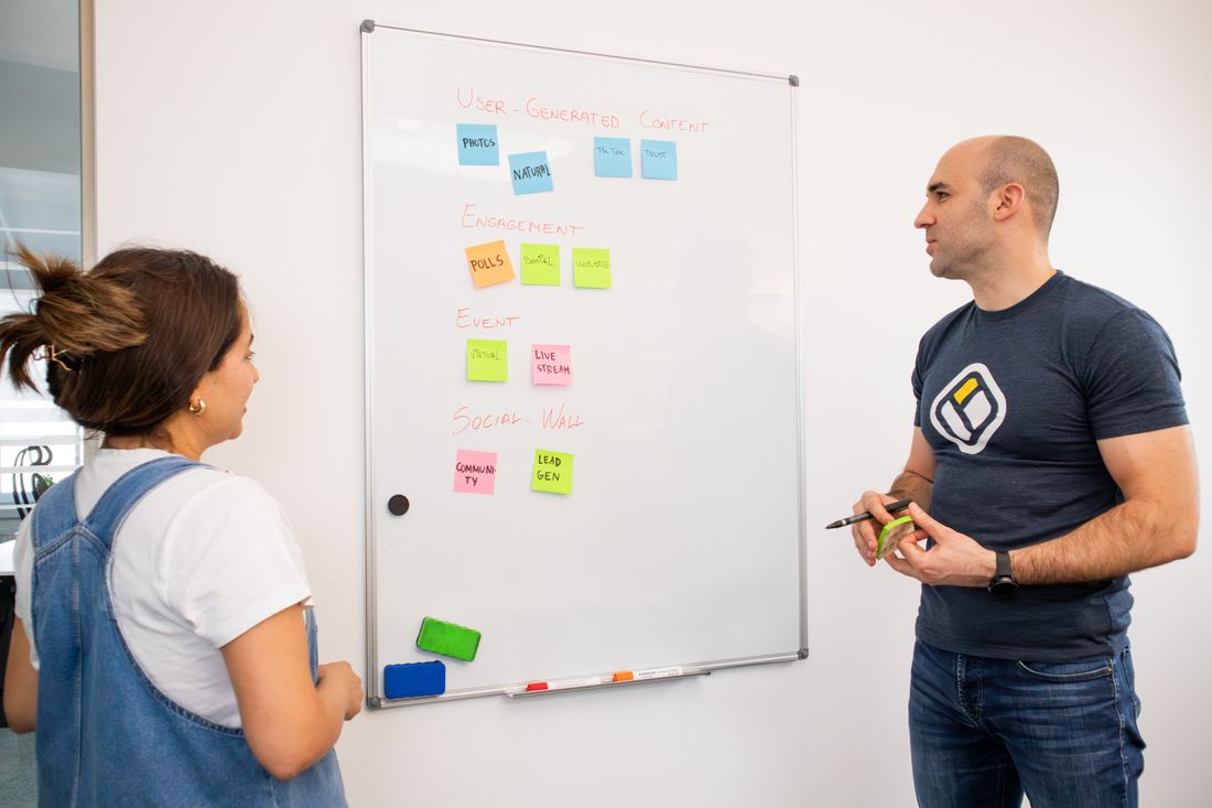 A team working through ideas at a whiteboard