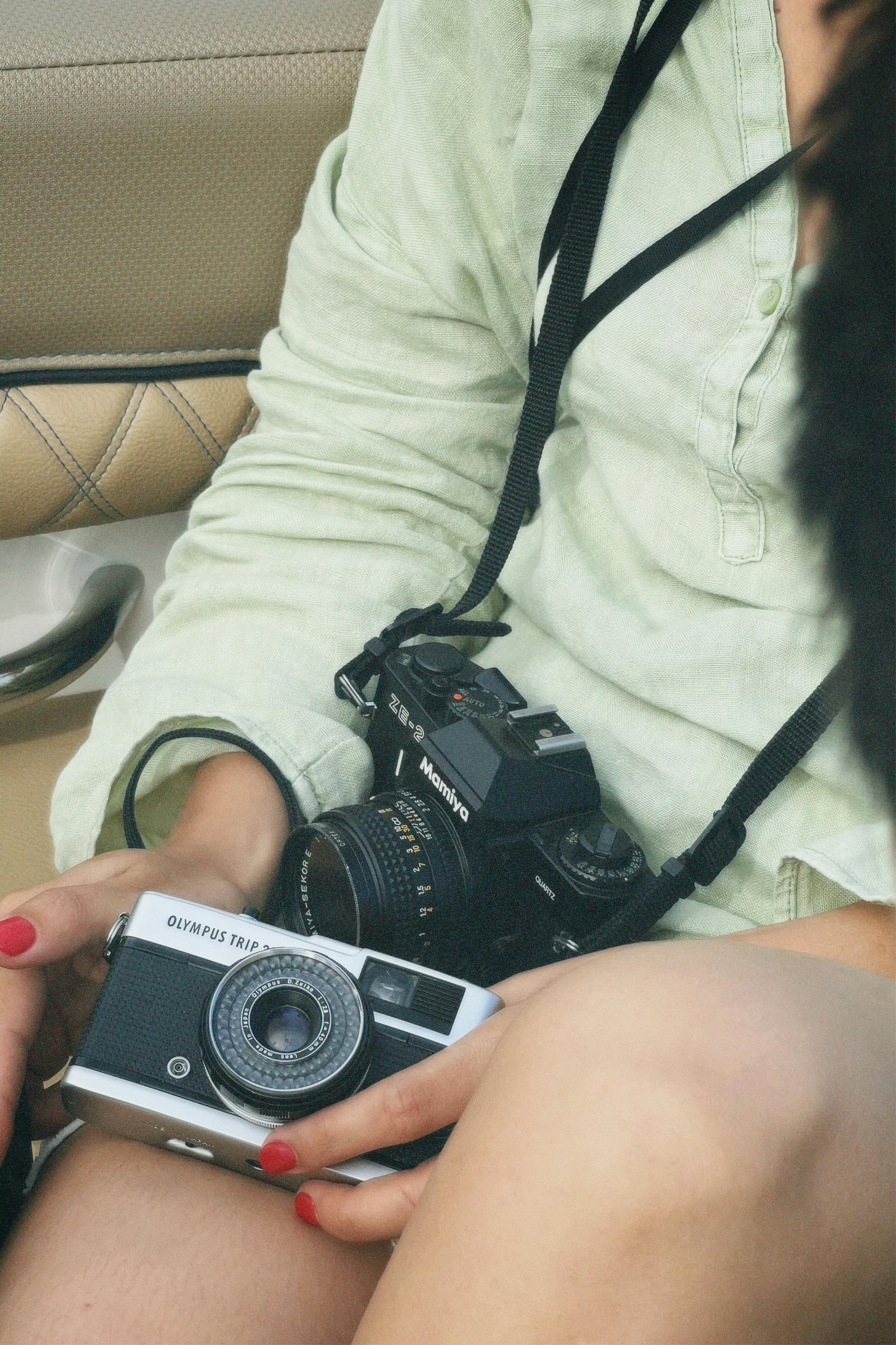 woman holding an analogue camera