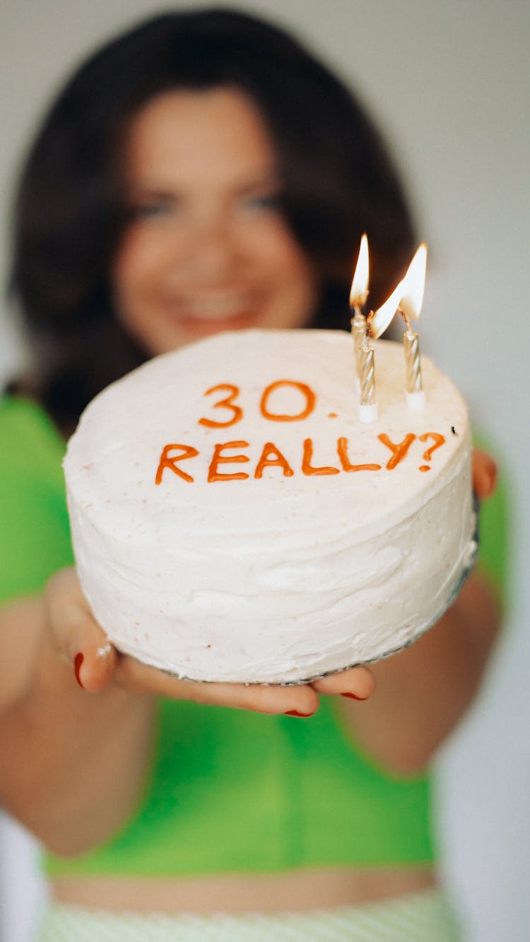 A Woman Holding A Birthday Cake