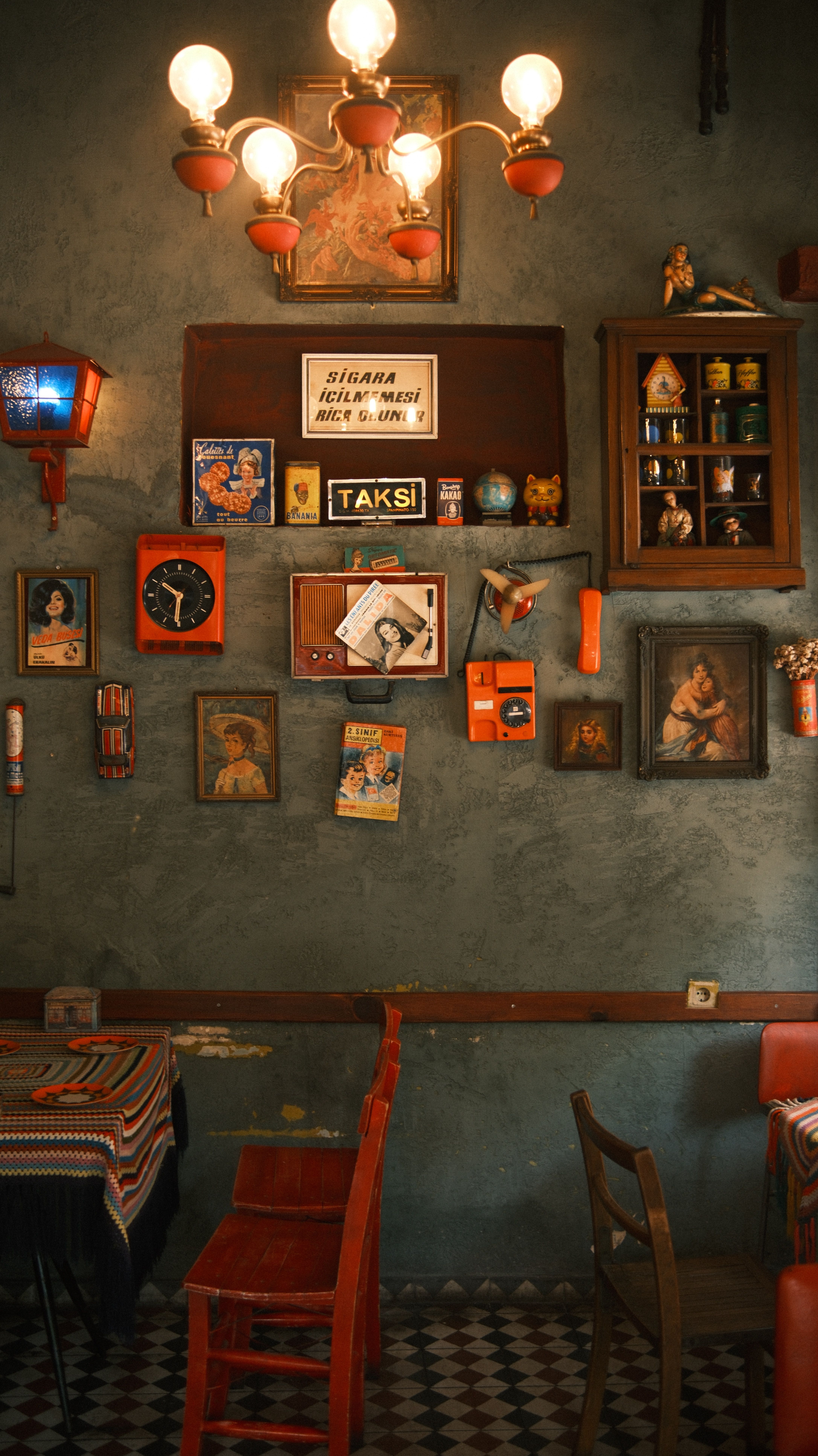 A cozy vintage cafe interior featuring retro decor, art, and unique furnishings.