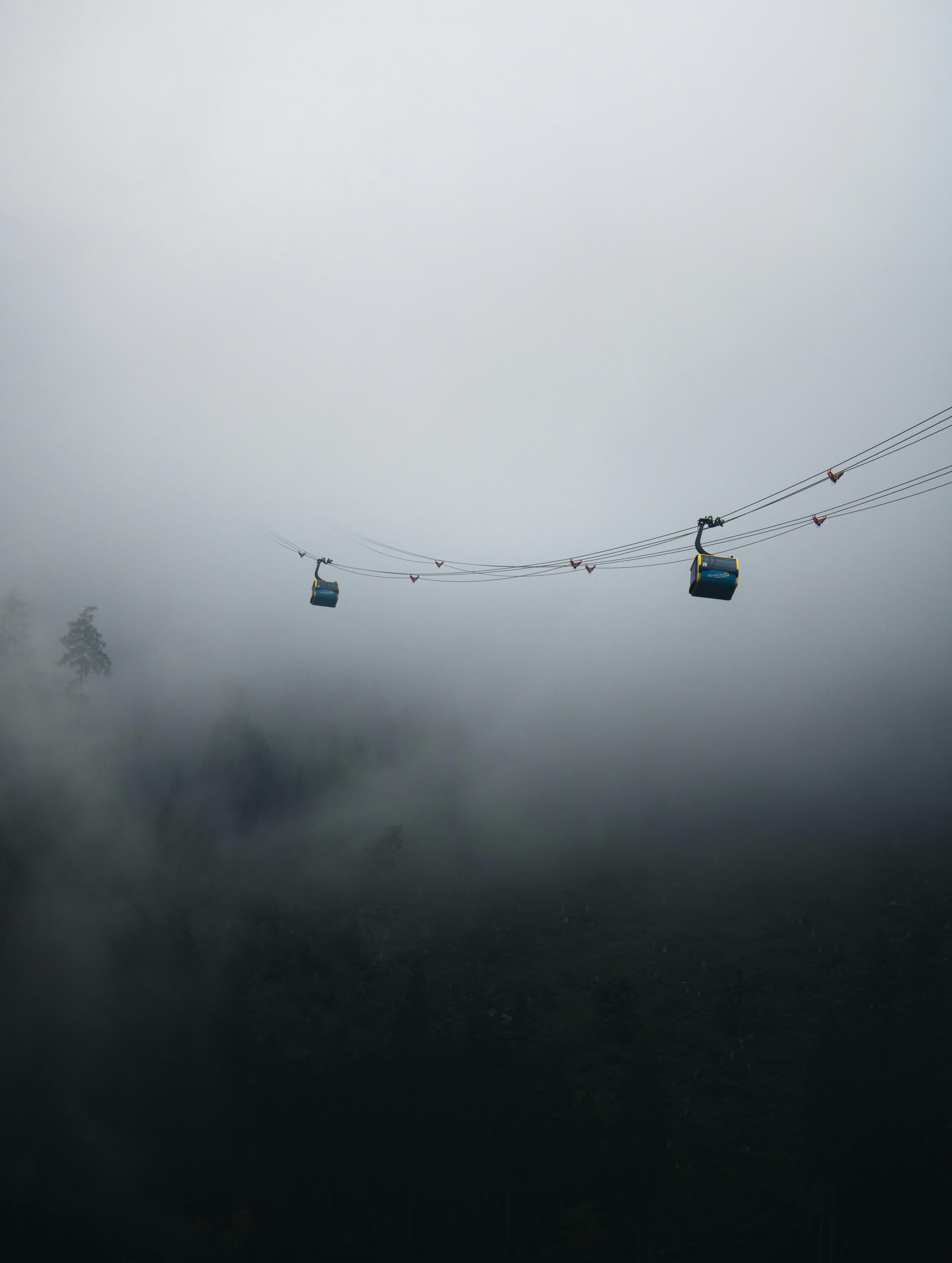 Cable cars in foggy Mayrhofen, Tirol. Captivating winter mountain scene.