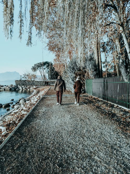 Unrecognizable people walking along embankment