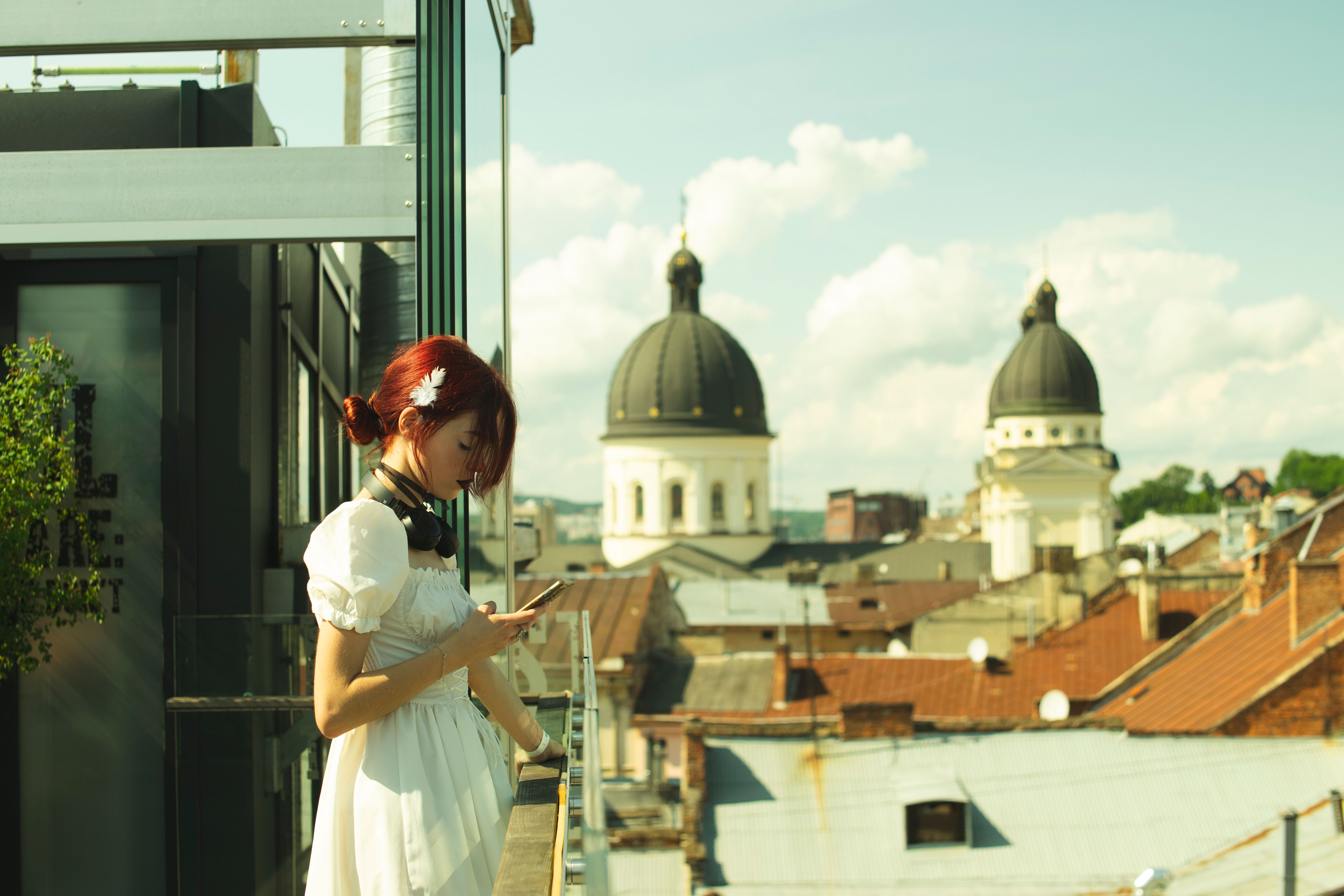 Girl With White Dress on a Terrace with View of a Church · Free Stock Photo