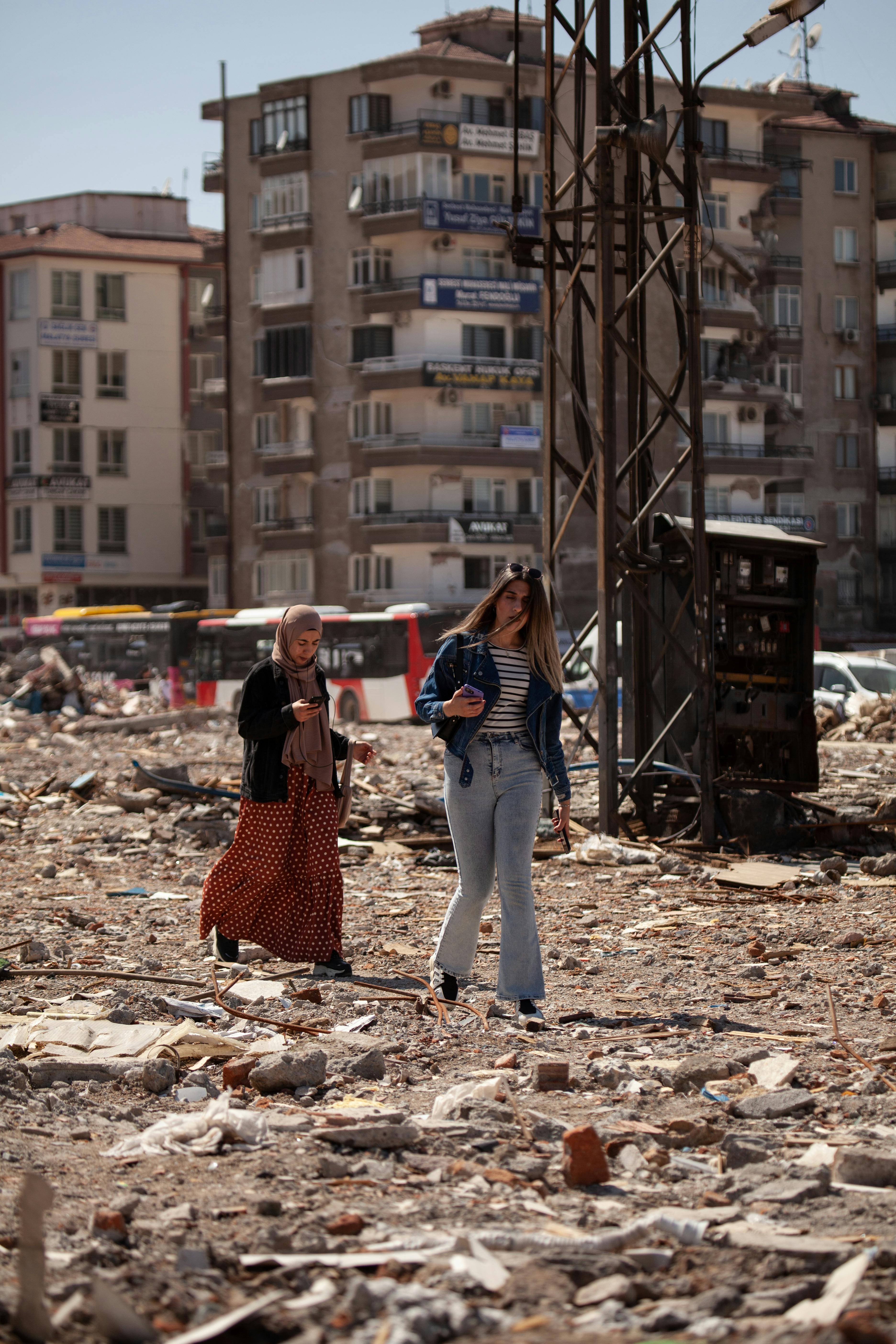 women walking among destroyed city