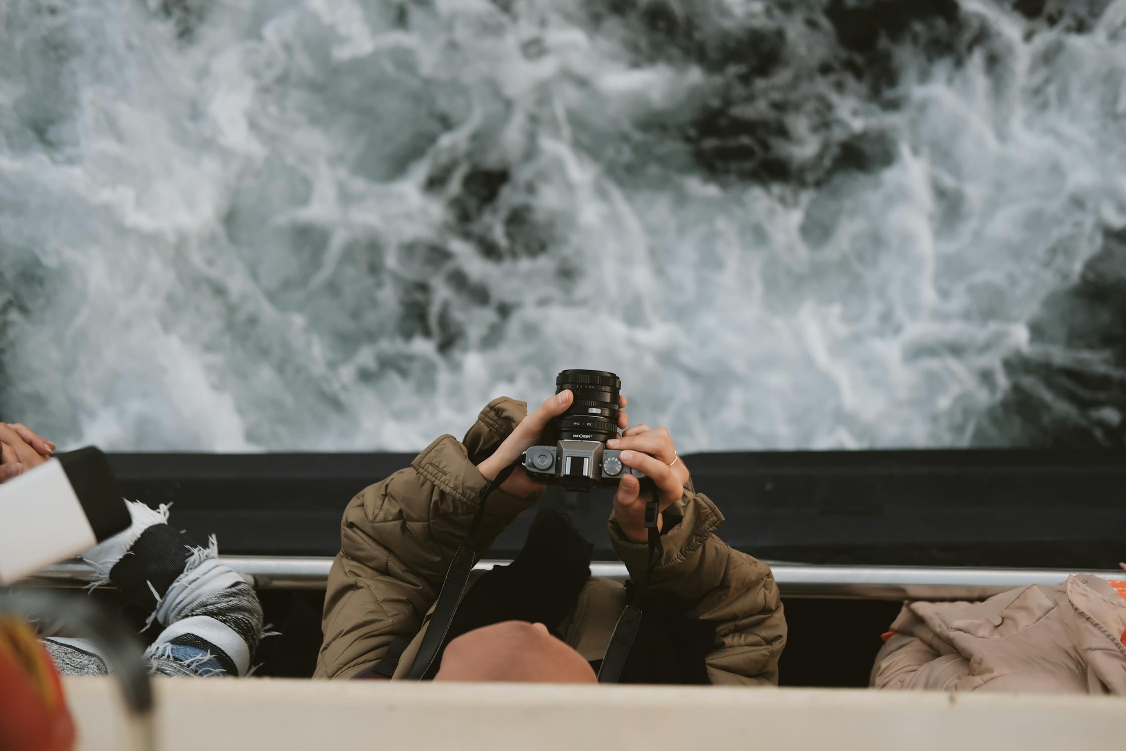 A person taking a photo of the ocean from a boat