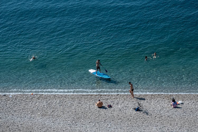 Man Surfing On Board In Sea At Seashore