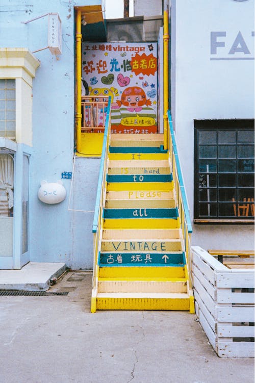 A stairway with colorful steps leading to a building