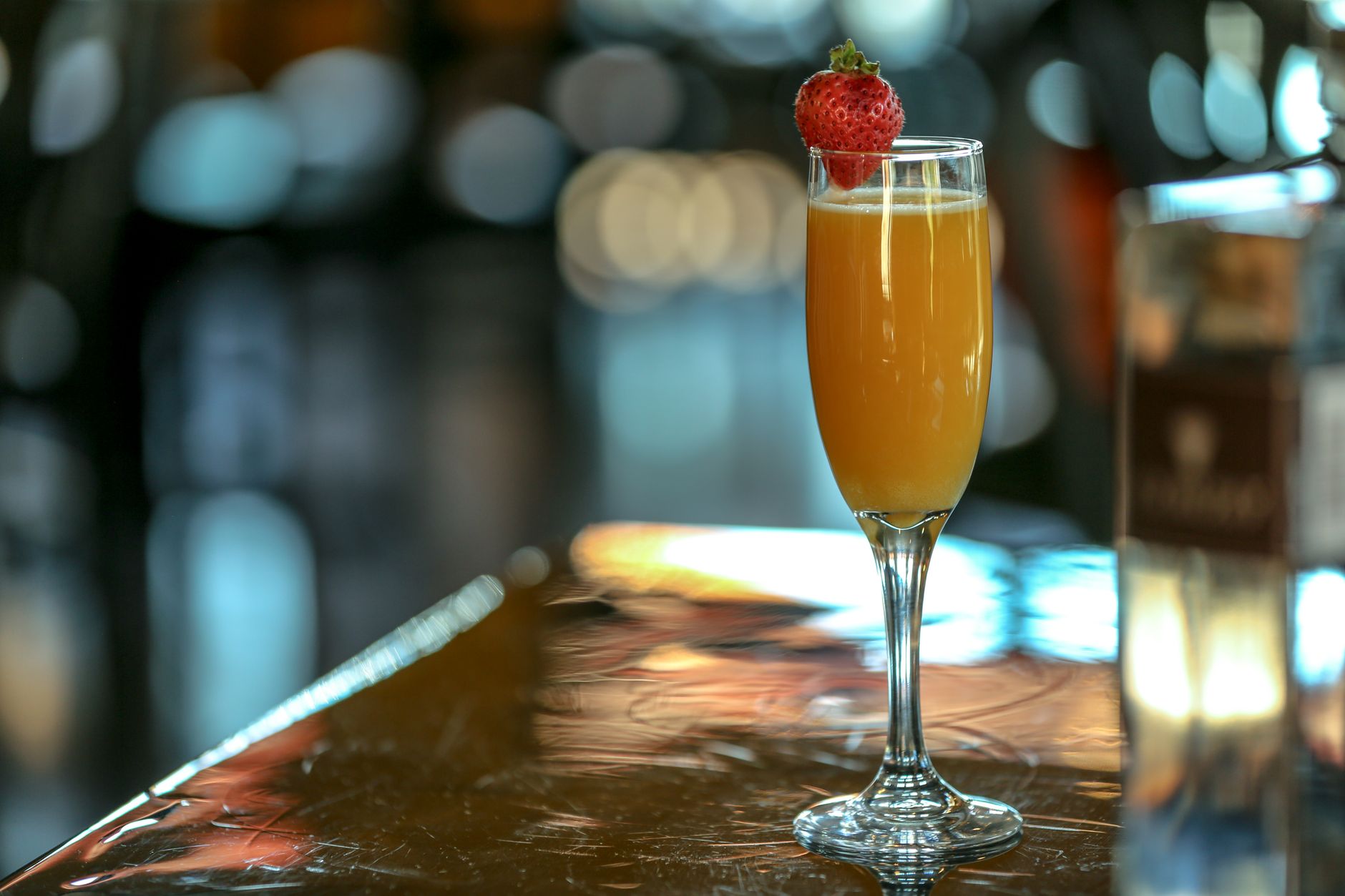 Orange Cream Mimosa garnished with strawberry on a white background