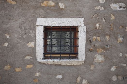 Small Window with Bars on Stone Wall
